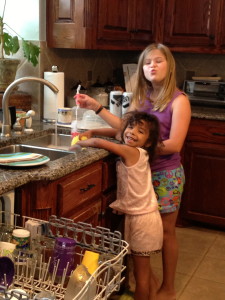 Washing dishes together. These girls love water and bubbles!